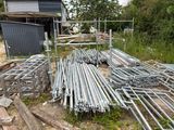 a lot of metal pipes that are laying on the ground
