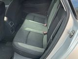 a silver car with its door open in a parking lot