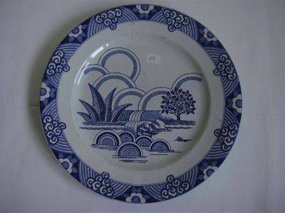 a blue and white plate with a design on it