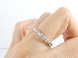 a woman ' s hand with a diamond ring on it