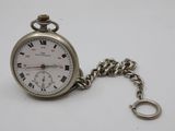 a silver pocket watch with roman numerals on it