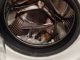 a close up of a washing machine with the door open