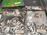 a lot of t - shirts in a box on the counter