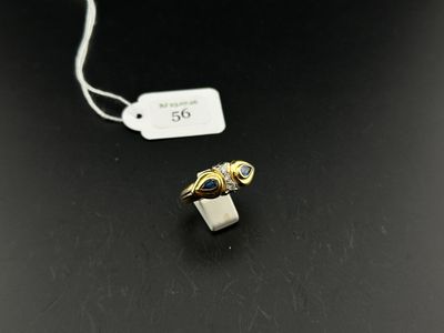 a close up of a ring on a table with a price tag
