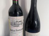 two bottles of wine sitting next to each other on a table