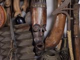 many different types of african art hanging on the wall