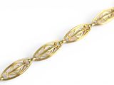 a close up of a gold bracelet on a white background