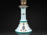an image of a blue and gold lamp with a light on it