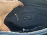 someone is holding a chanel bag in their hand