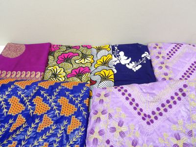 several different types of cloths laid out on a bed