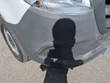 a shadow of a person standing in front of a car
