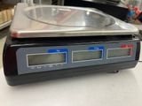 a digital scale that is on a counter in a store