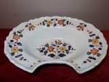 a white plate with flowers on it on a red table