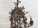 a candle holder with a bird on it on a table