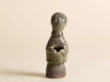 une petite statue représentant une femme tenant un chat
