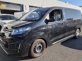 a picture of a black van parked in front of a building