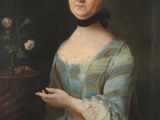 portrait d'une femme en robe bleue tenant une fleur