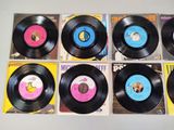 six vinyl records are lined up in a row on a table