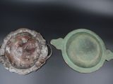 a green bowl and a brown bowl sitting on a table