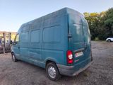 a blue van that is parked in a lot