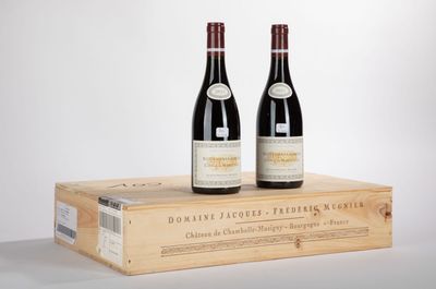 two bottles of wine sitting on top of a wooden box