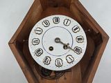 a clock that is sitting in a wooden box