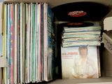 a cardboard box filled with a lot of records