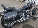 a black motorcycle parked in front of a garage