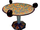 a colorful table with two black balls on top of it