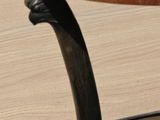 a small table with a black top and a wooden base
