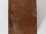 an old book sitting on a white table