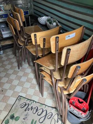 six wooden chairs sitting in a row in a room