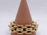 brown cone with gold rings sitting on top of it on a white surface