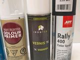 many different types of spray paint on a white surface