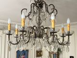 a chandelier that is hanging from the ceiling in a living room