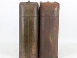 pair of antique metal canisters with rusted paint on them