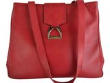 a red leather handbag with a metal ring on the front