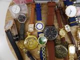 many different types of watches on a wooden table