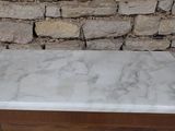 a marble top table with a drawer underneath it