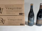 two bottles of wine are sitting next to a box of wine