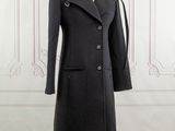 the coat is black and has buttons on the collar