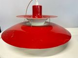 an image of a red and white lamp on a white table