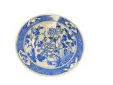a blue and white plate with flowers on it
