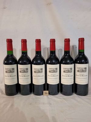six bottles of wine are lined up on a table