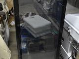 a refrigerator with a glass door in a garage