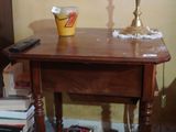 a table with a lamp on top of it in a room