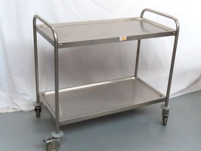 a stainless steel cart with wheels on the floor