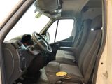 the interior of a white van with black seats and a steering wheel