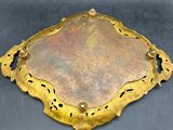 a gold plate on a black surface with a black background