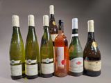 bottles of wine are lined up in a row on a table
